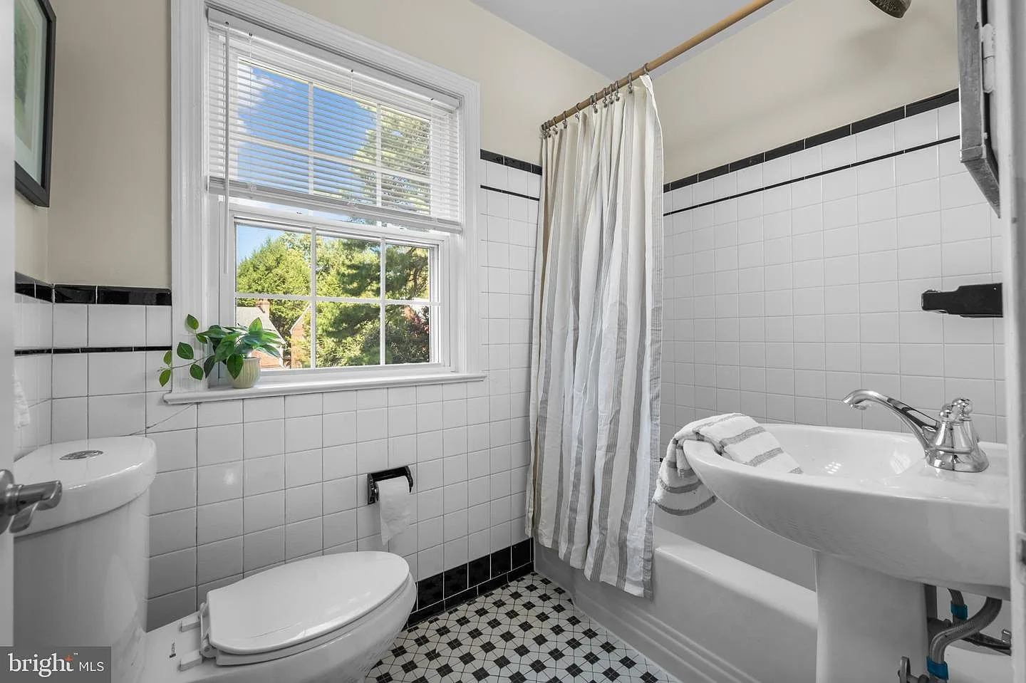 Bathroom with subway tile and checkerboard floor