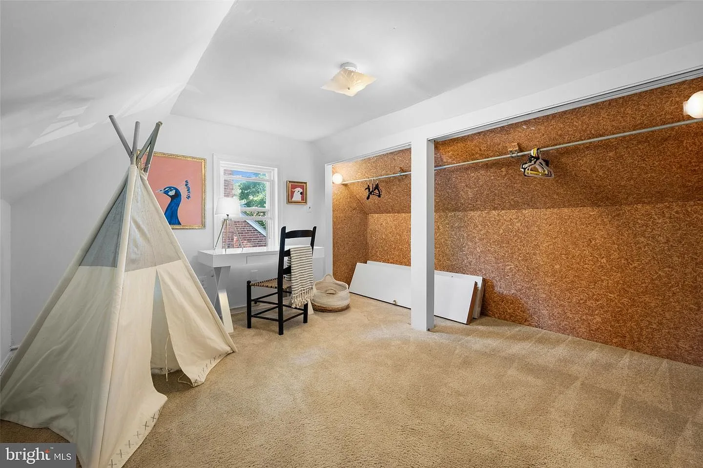 Bedroom with sloped ceiling and cork-walled closet