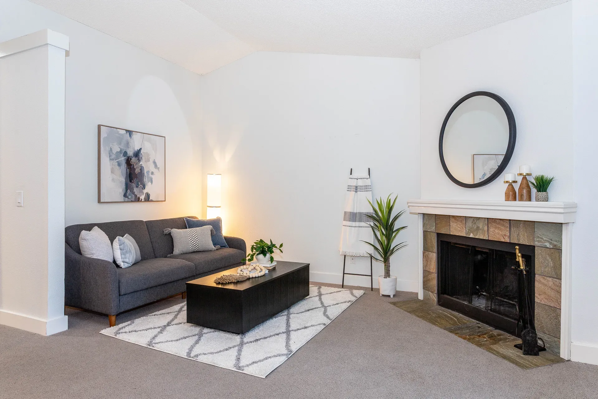 The great room of G301 at Horizon Village with vaulted ceilings, a wood-burning fireplace, and large picture windows