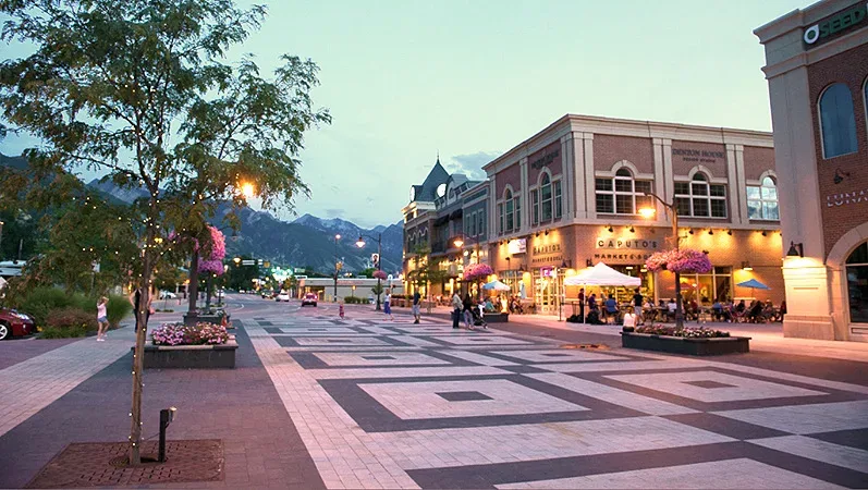 Holladay Village's pedestrian shopping plaza glowing at dusk