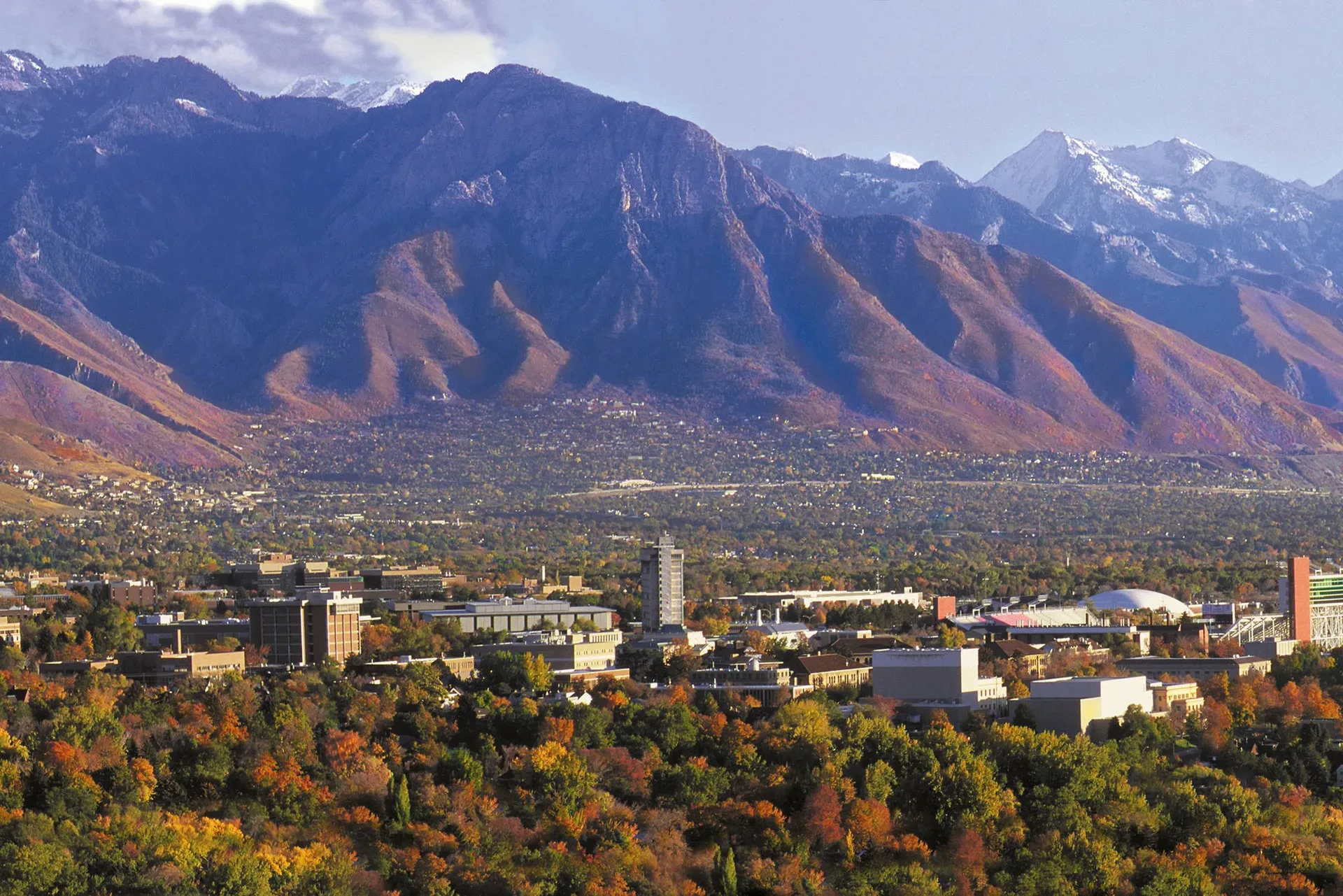 A wide view of the Salt Lake Valley at the foot of the snow-capped Wasatch Range in autumn