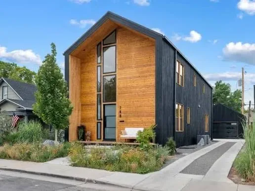 A modern wood facade on a 9th and 9th home, clean contemporary cladding standing beside older brick houses