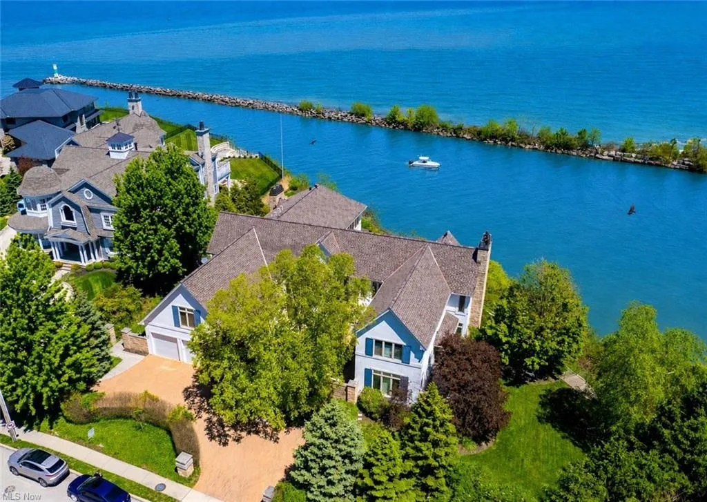 Drone aerial view of the Lake Erie shore and dock at 19486 Frazier Dr in Rocky River, Ohio