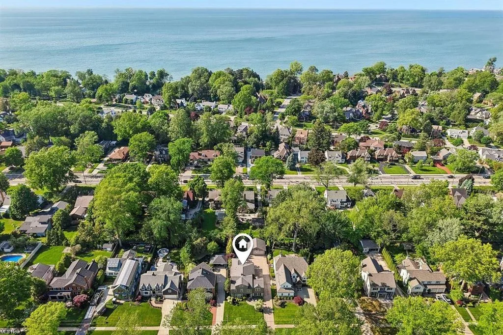 Aerial view of the lakefront home and Lake Erie shore at 20646 Beaconsfield Blvd in Rocky River, Ohio