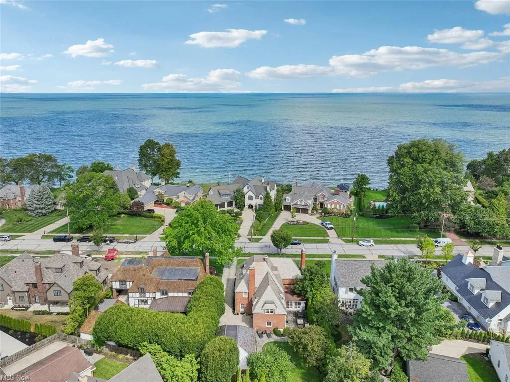 Aerial view of the lakefront home and Lake Erie shore at 21891 Avalon Dr in Rocky River, Ohio