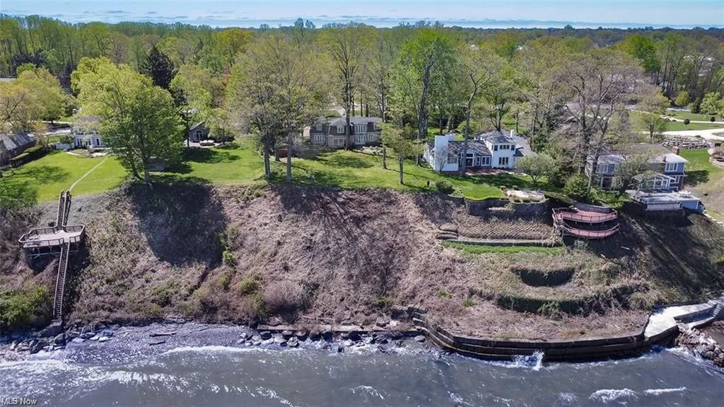 Aerial rear view of the lakefront property, terraced decks and Lake Erie shore at 22100 Lake Rd in Rocky River, Ohio