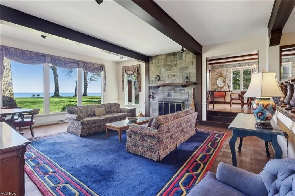 Family room with lake views and stone fireplace at 22100 Lake Rd in Rocky River, Ohio