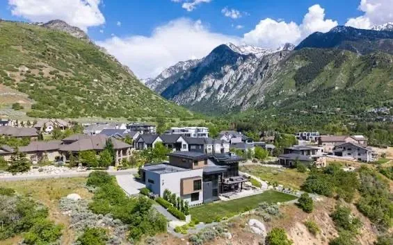 A drone view of modern mountain homes on the bench beneath the Wasatch peaks