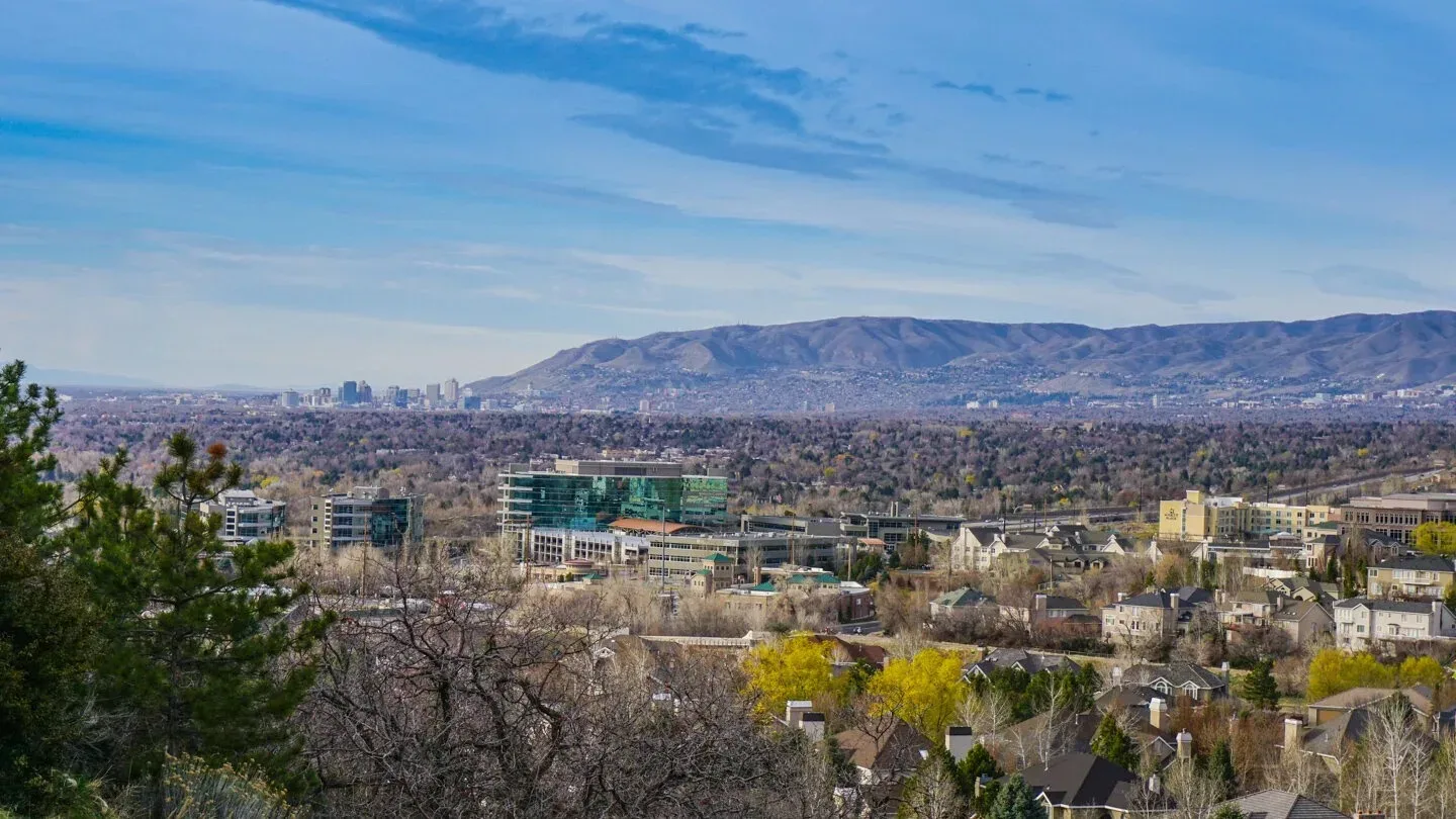 A high view over Cottonwood Heights toward the city skyline and the Wasatch