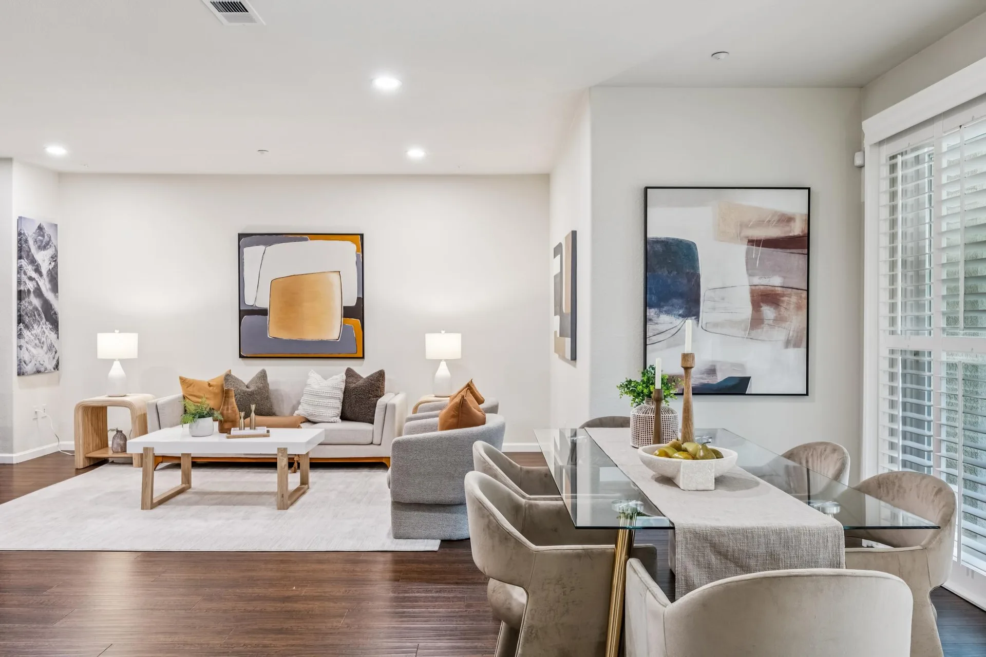 Living and dining area styled with sofa, armchairs and a six-seat dining table