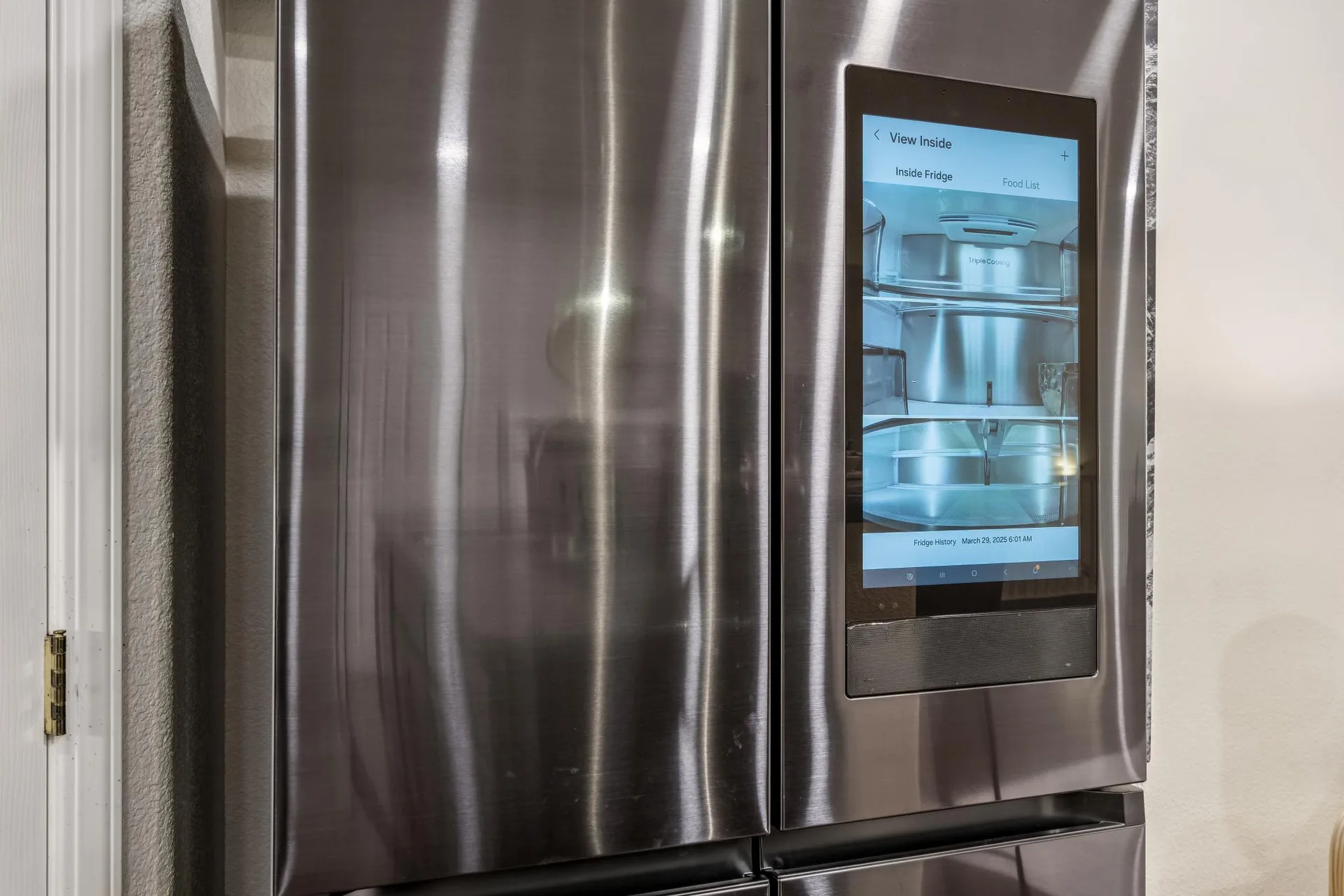 Stainless steel smart refrigerator in the kitchen