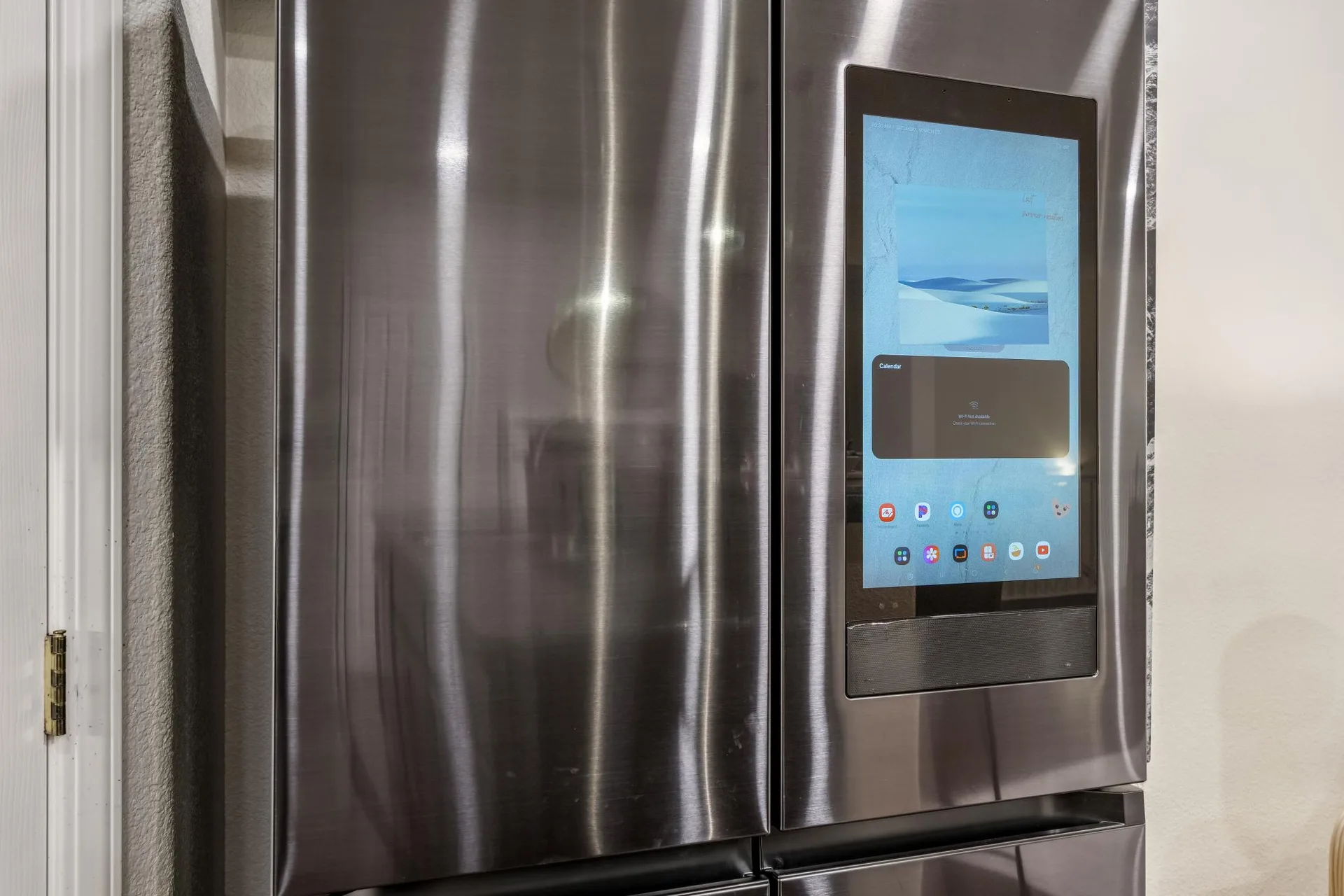 Premium stainless refrigerator with a built-in touchscreen display