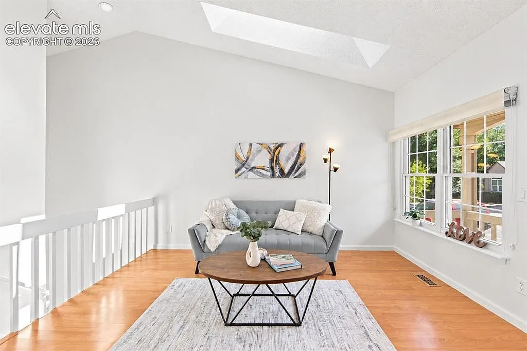 Vaulted living room with skylight and hardwood floors at 2552 Blazek Loop