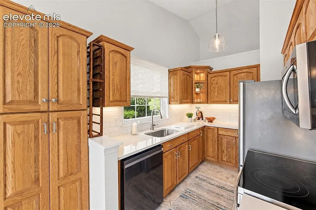 Updated kitchen with quartz countertops and subway-tile backsplash