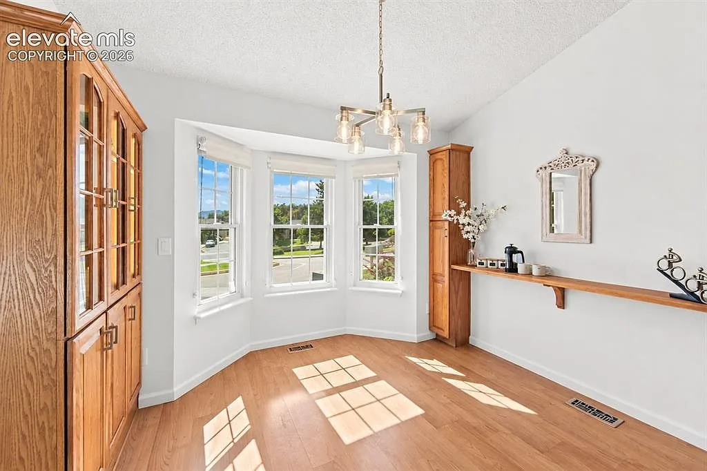 Dining room with a bay window and bright natural light
