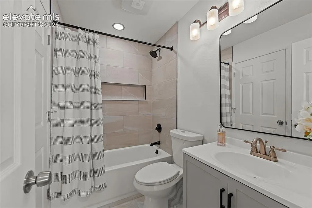 Bathroom with gray vanity and matte black fixtures