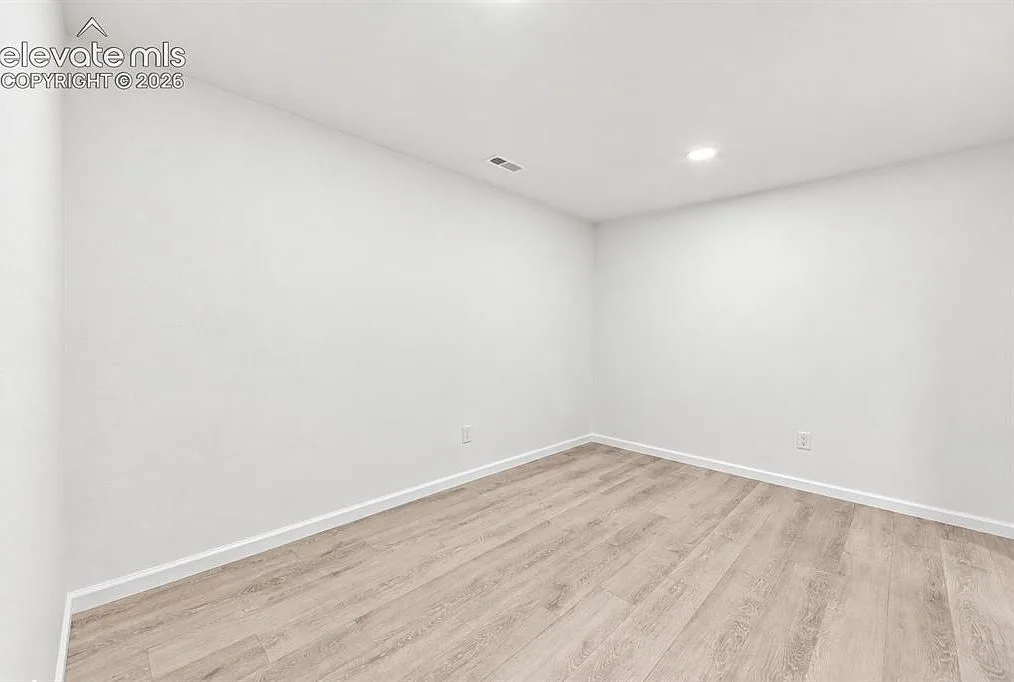 Flexible lower-level room with fresh paint and recessed lighting