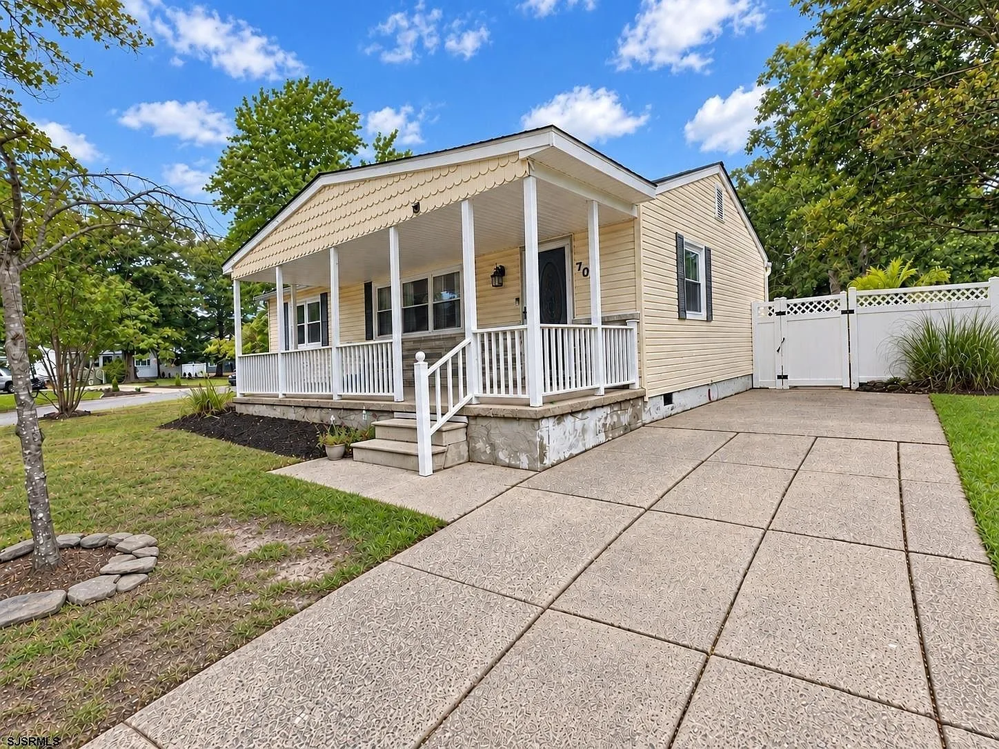 Front elevation with driveway and landscaped front yard