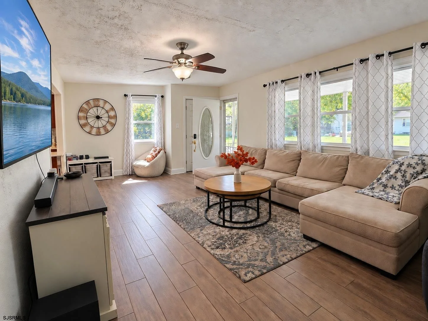 Living room with large windows and wood-look flooring