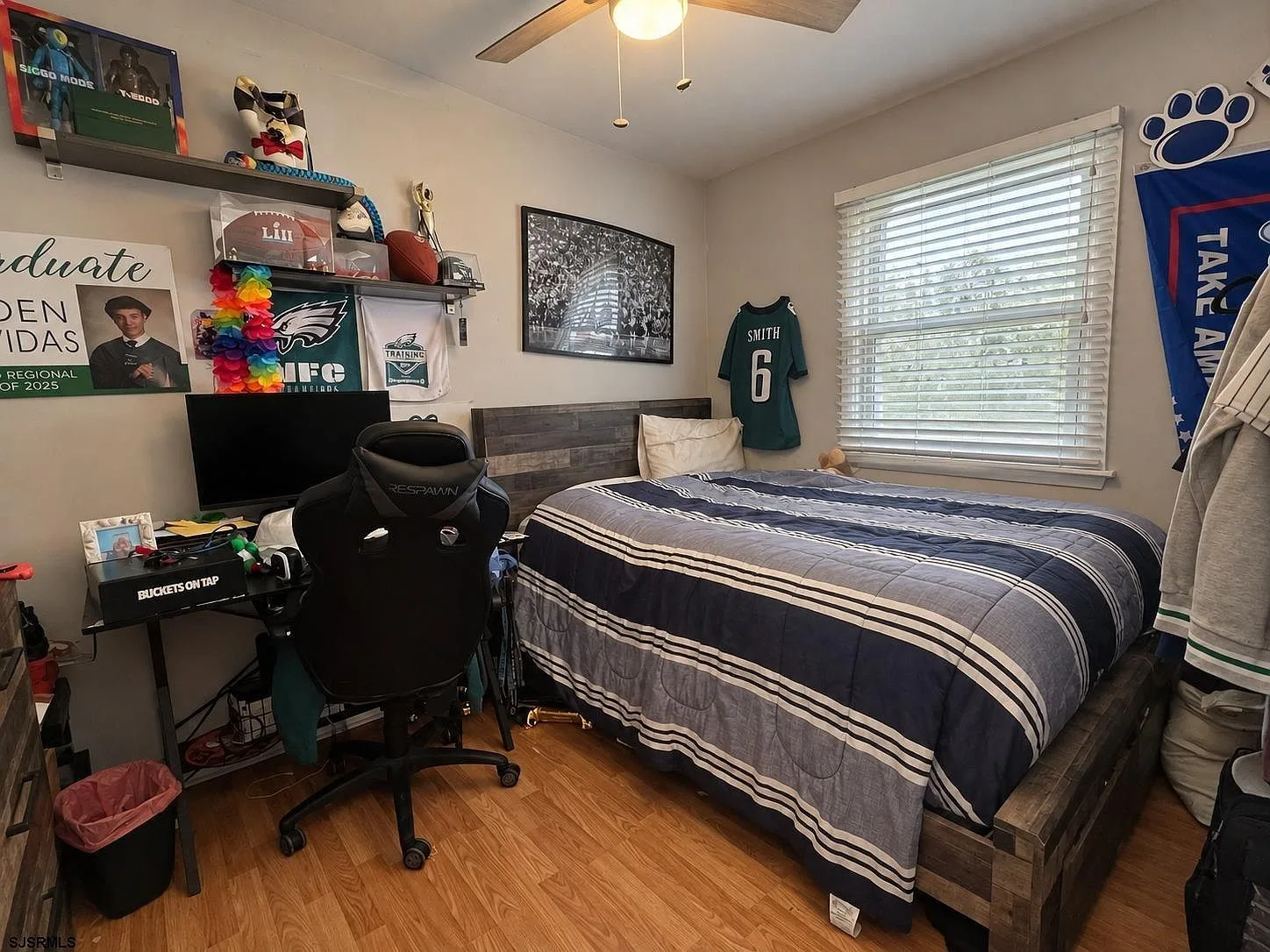 Secondary bedroom with wood-look flooring