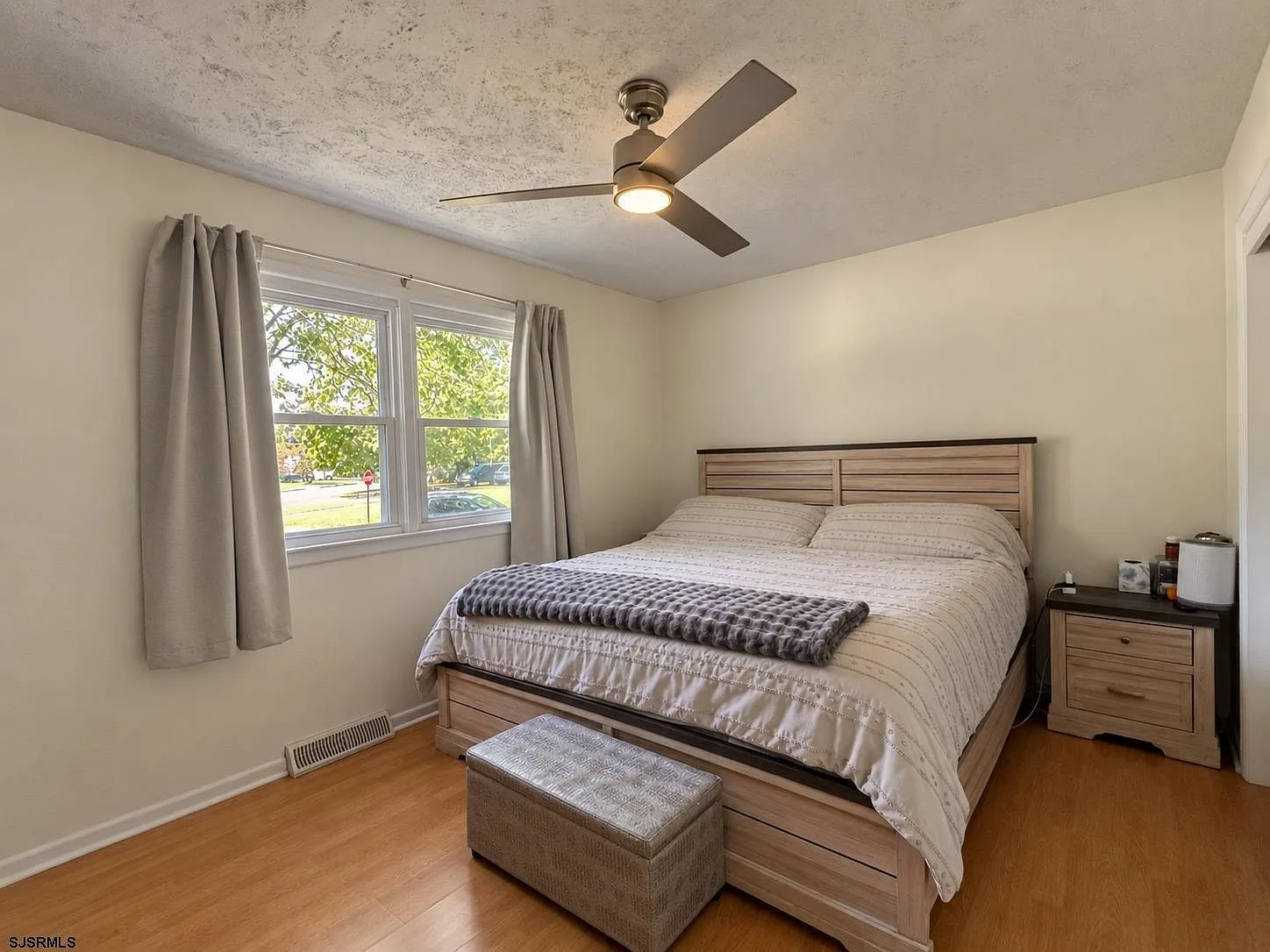 Primary bedroom with a window facing the street