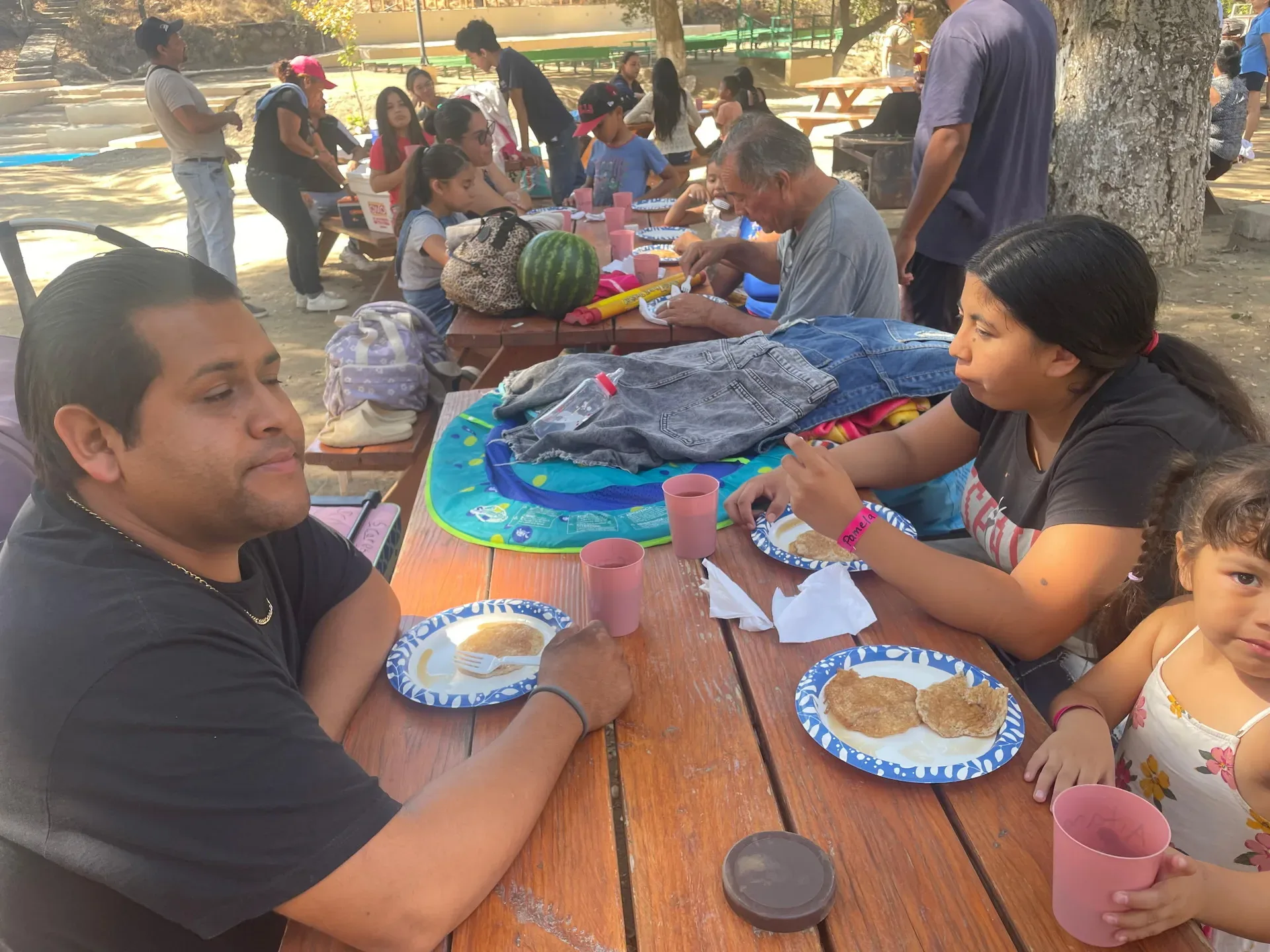 Outdoor picnic gathering at Brenda's outreach where everyone enjoyed the pancakes