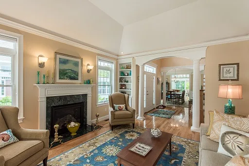 A traditional North Shore living room with a fireplace and high ceilings