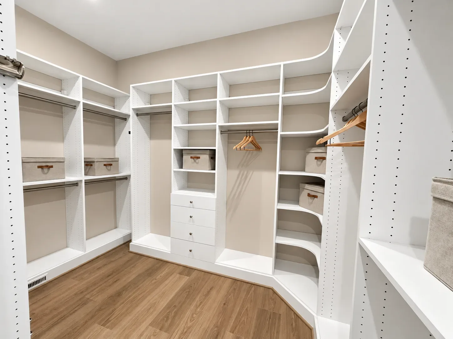 Walk-in closet with built-in shelving and hanging storage in a new construction primary suite