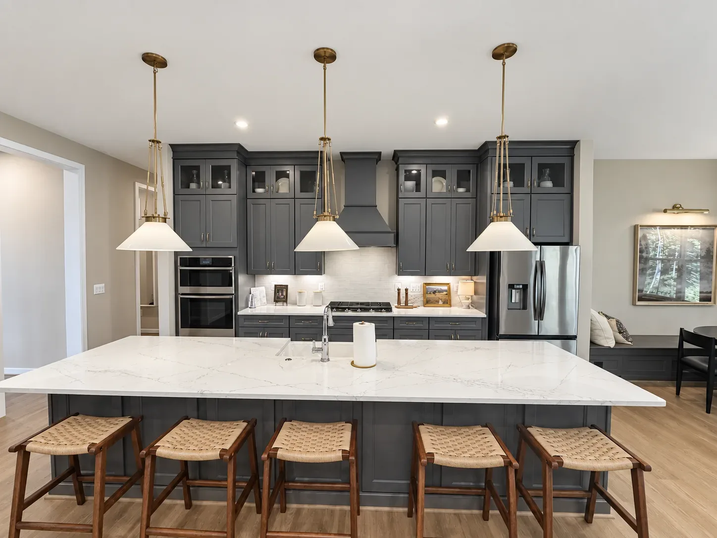 Modern navy blue kitchen island with seating in a newly built home