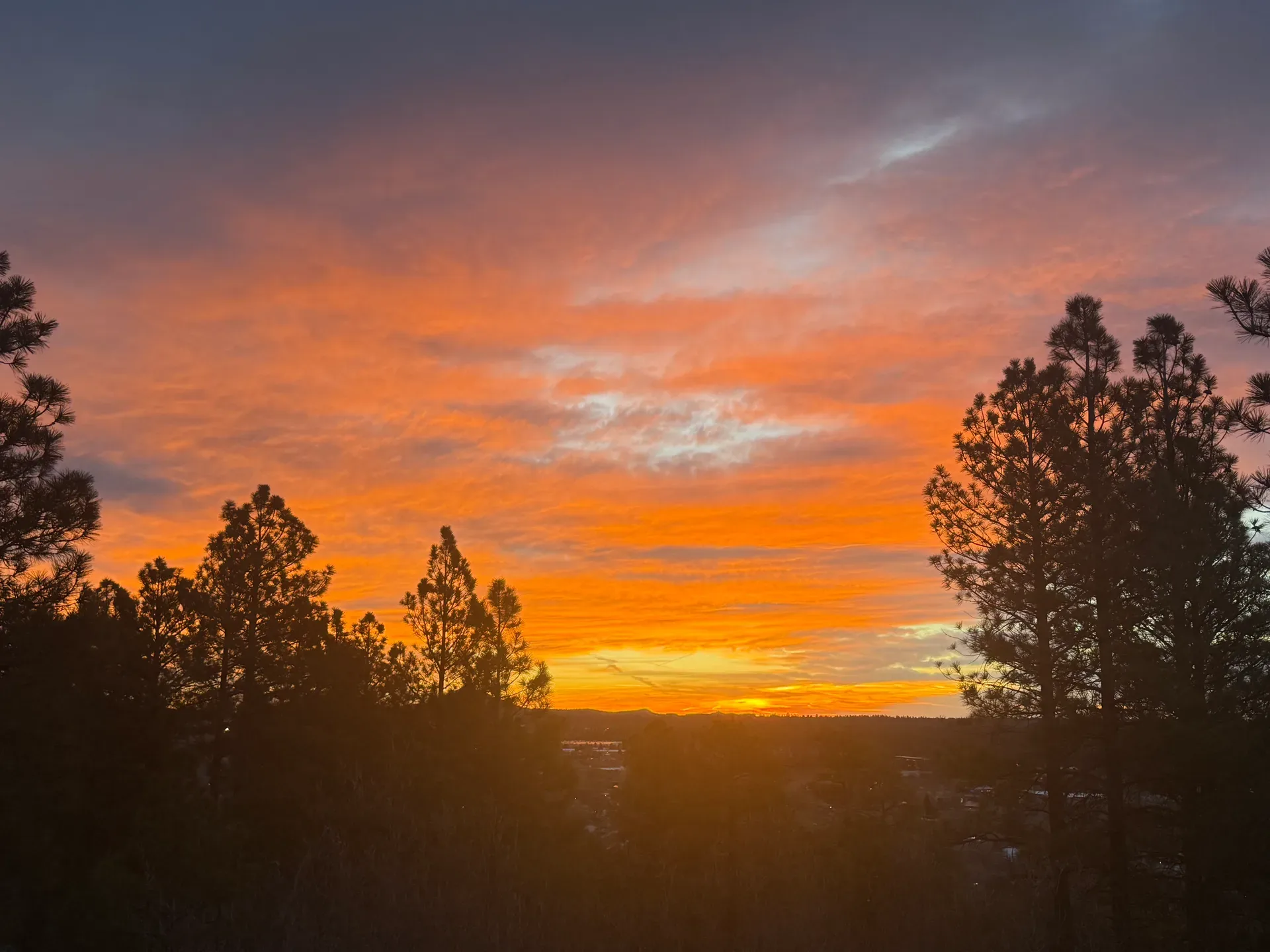 Sunset sky over the pine-framed ridge above Pine Valley, the northern view held open