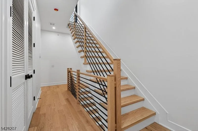 Staircase with oak treads and black metal balusters