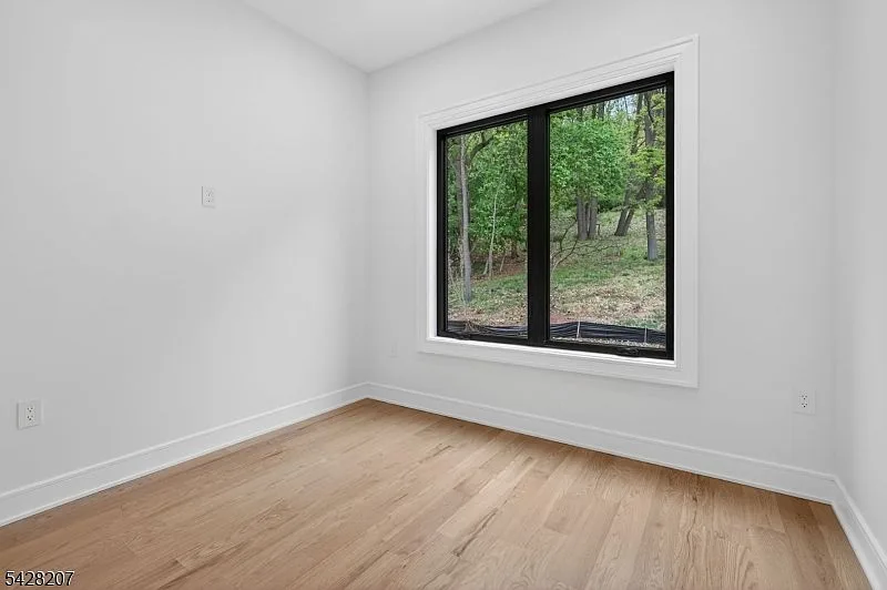 Secondary bedroom with a black-framed window