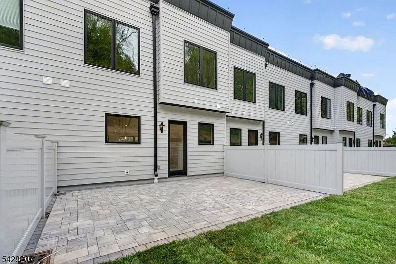 Rear paver patio enclosed by privacy fencing at the townhome