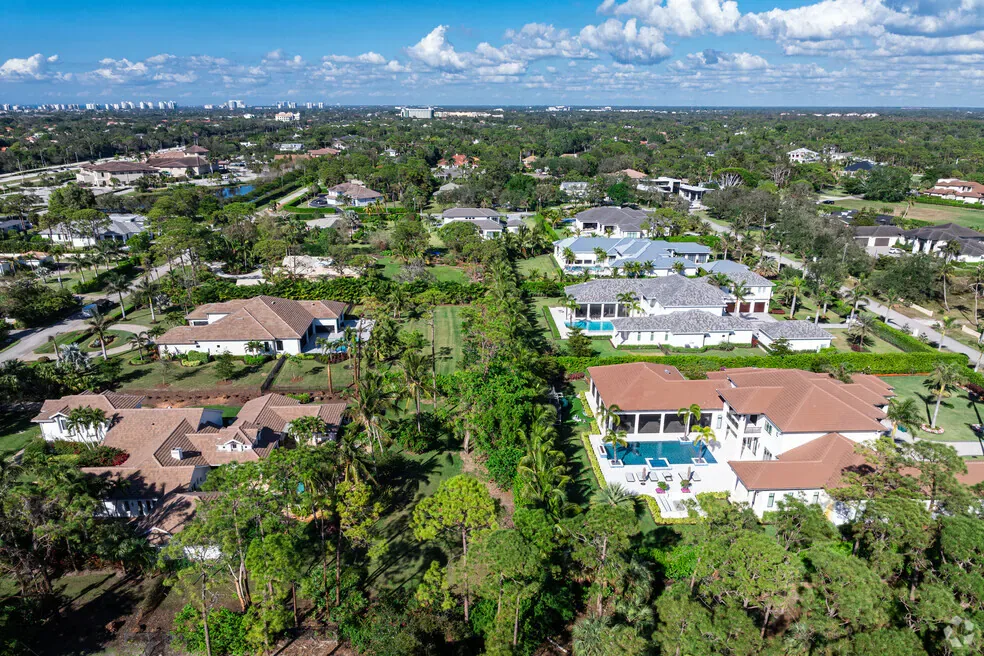 Aerial view of a Naples residential neighborhood with single-family homes, pools, and lush landscaping, showing the variety of communities buyers choose between