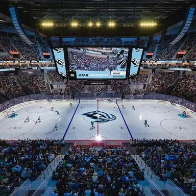 A concept rendering of Utah Mammoth home ice at the Delta Center, with the UTAH MAMMOTH wordmark on the scoreboard above the center ice logo