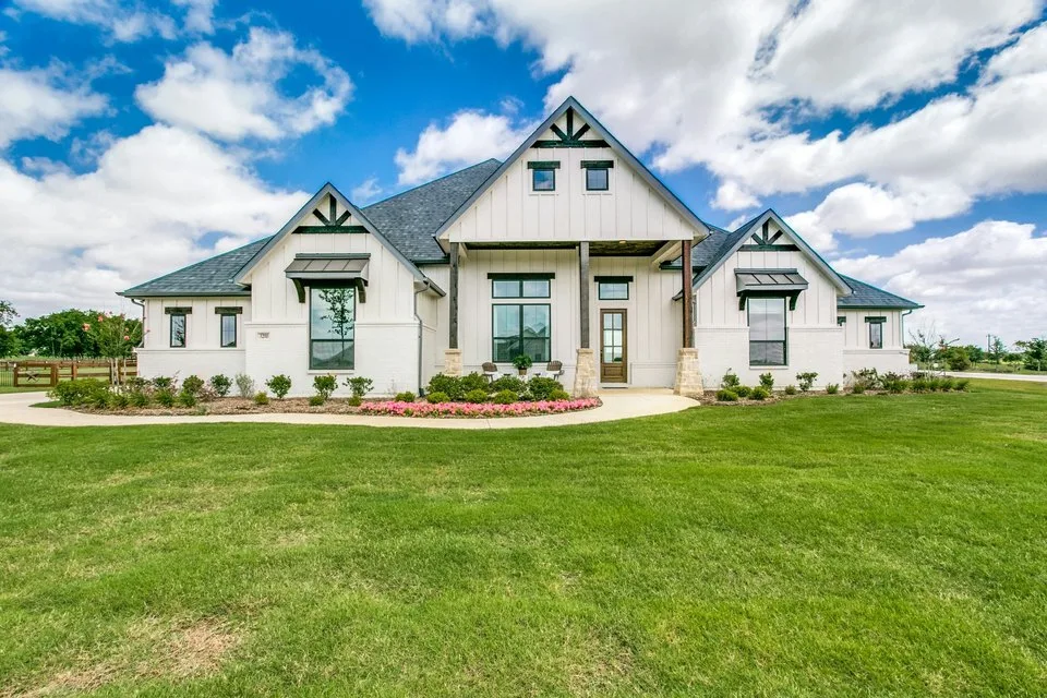 A clean modern-farmhouse exterior with a dark roof in Northlake, Texas