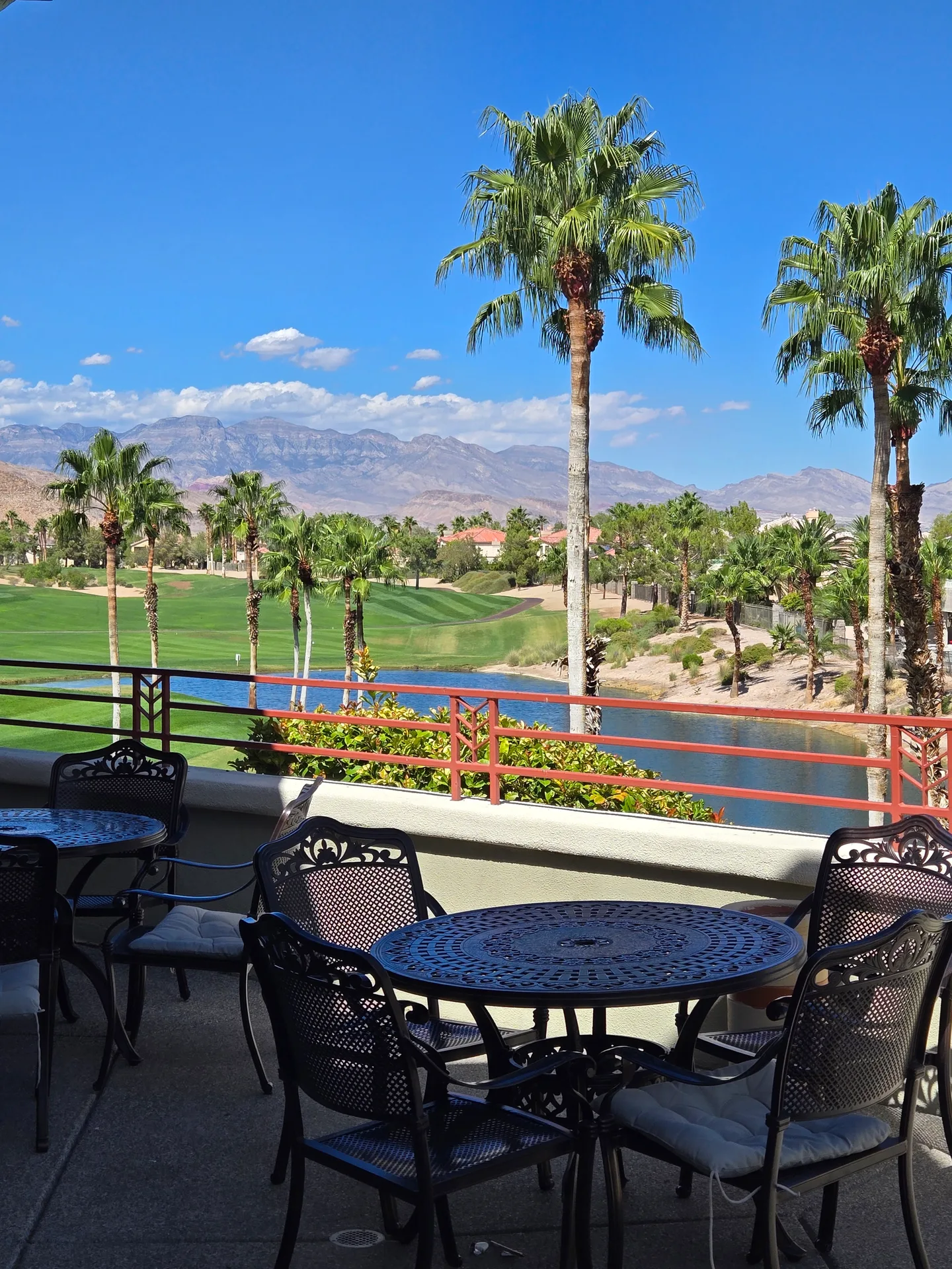 Martin's photo of the mountain, lake, and golf course view from a backyard patio at Rhodes Ranch on a sunny day