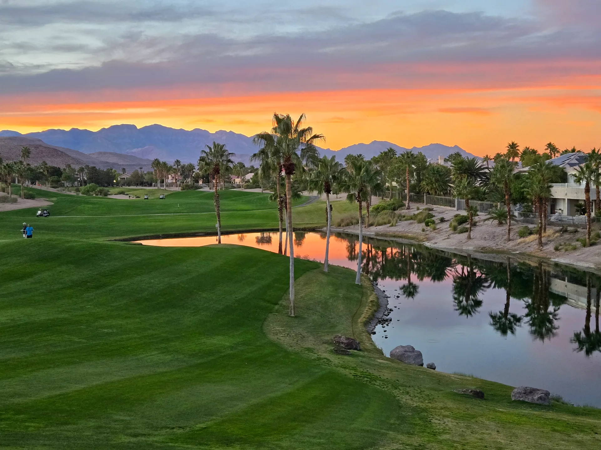 Martin's photo of the Rhodes Ranch golf course at sunset with a vibrant orange and purple sky over the pond and mountains