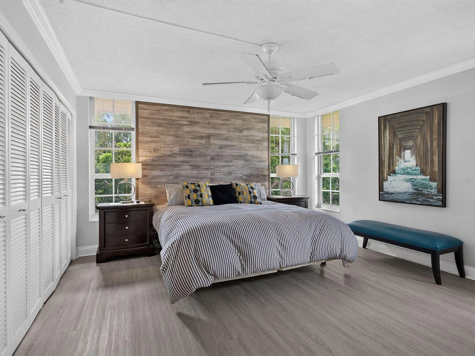 Master bedroom with a light wood accent wall
