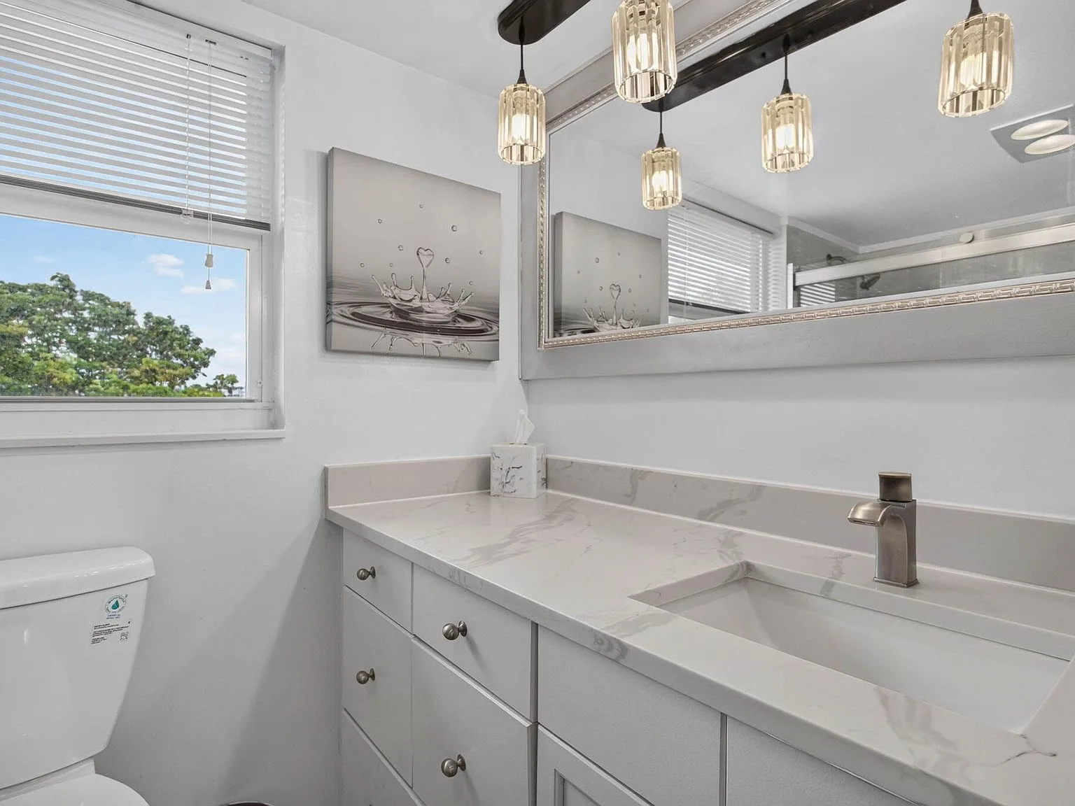 Remodeled master bathroom vanity with quartz countertop