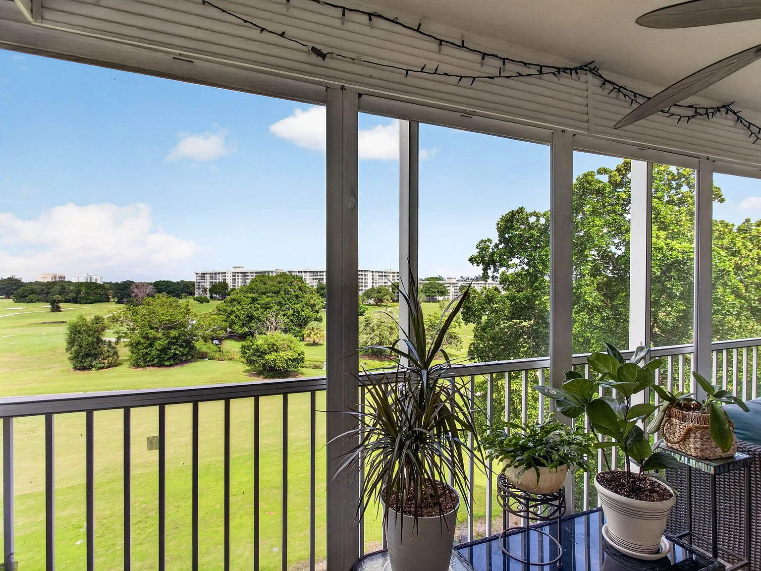Screened patio at 2901 S Palm Aire Drive #610 looking over the golf course and lake