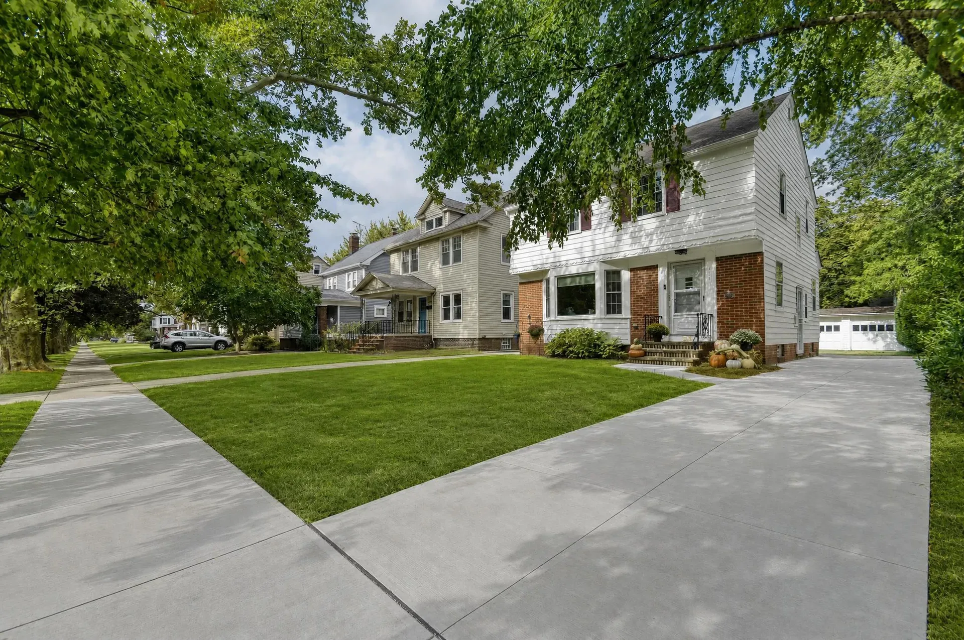 171 E 212th St, a Colonial home with a new concrete driveway and walkway in Euclid, Ohio