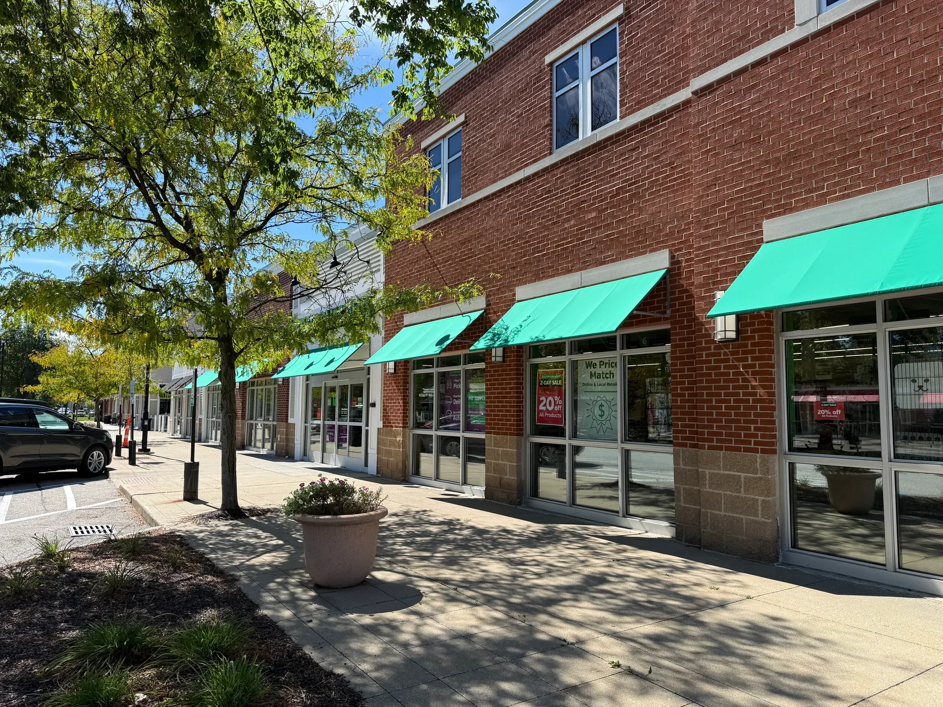 Brick storefronts with green awnings at Brunswick Town Center in Brunswick, Ohio
