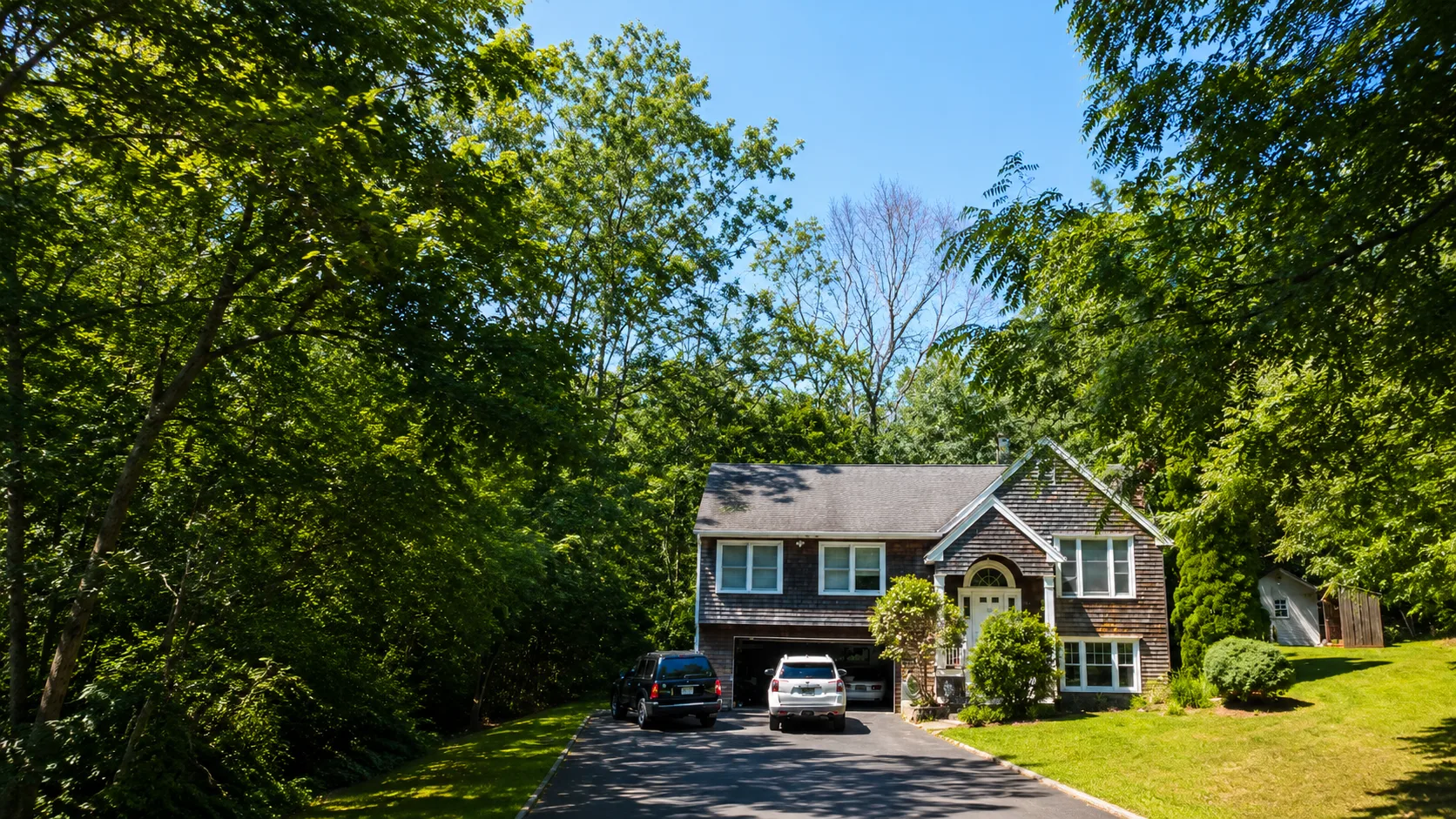 A traditional shingle-style North Shore home surrounded by trees