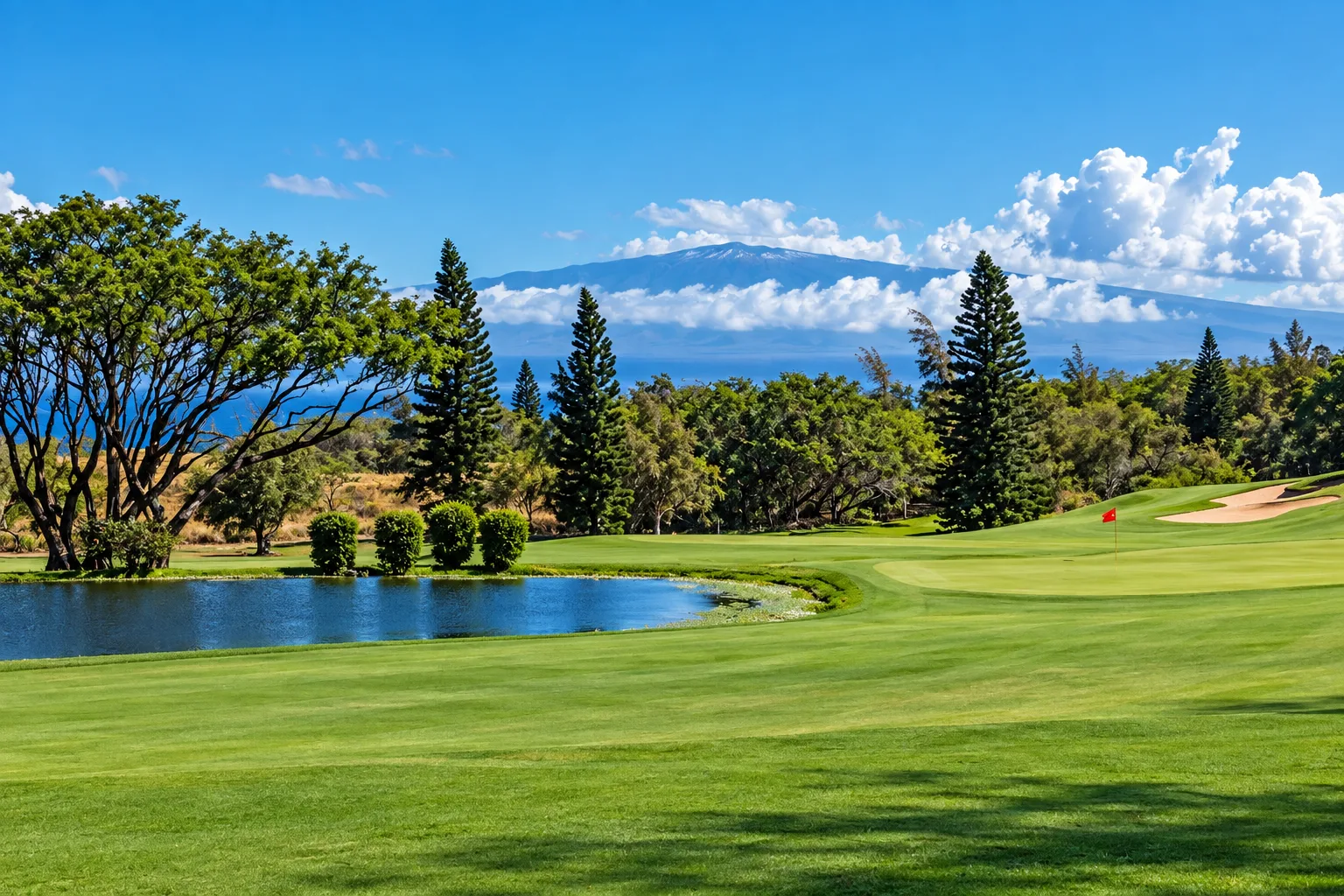 A fairway at the Waikoloa Village golf course with Mauna Kea rising behind it