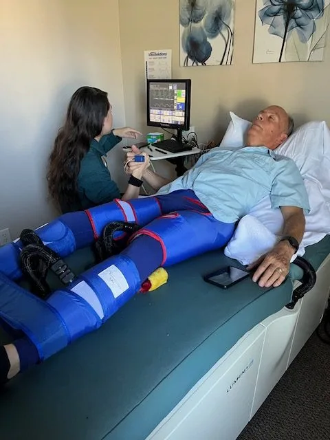 A patient undergoing EECP therapy on a treatment bed at Thrive EECP in Draper, Utah