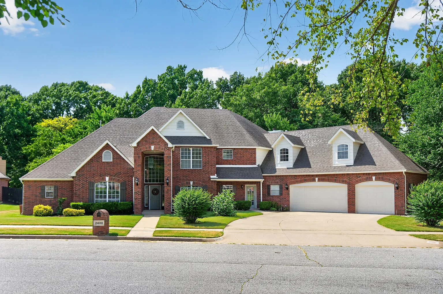 Front facade of the brick home on a clear day