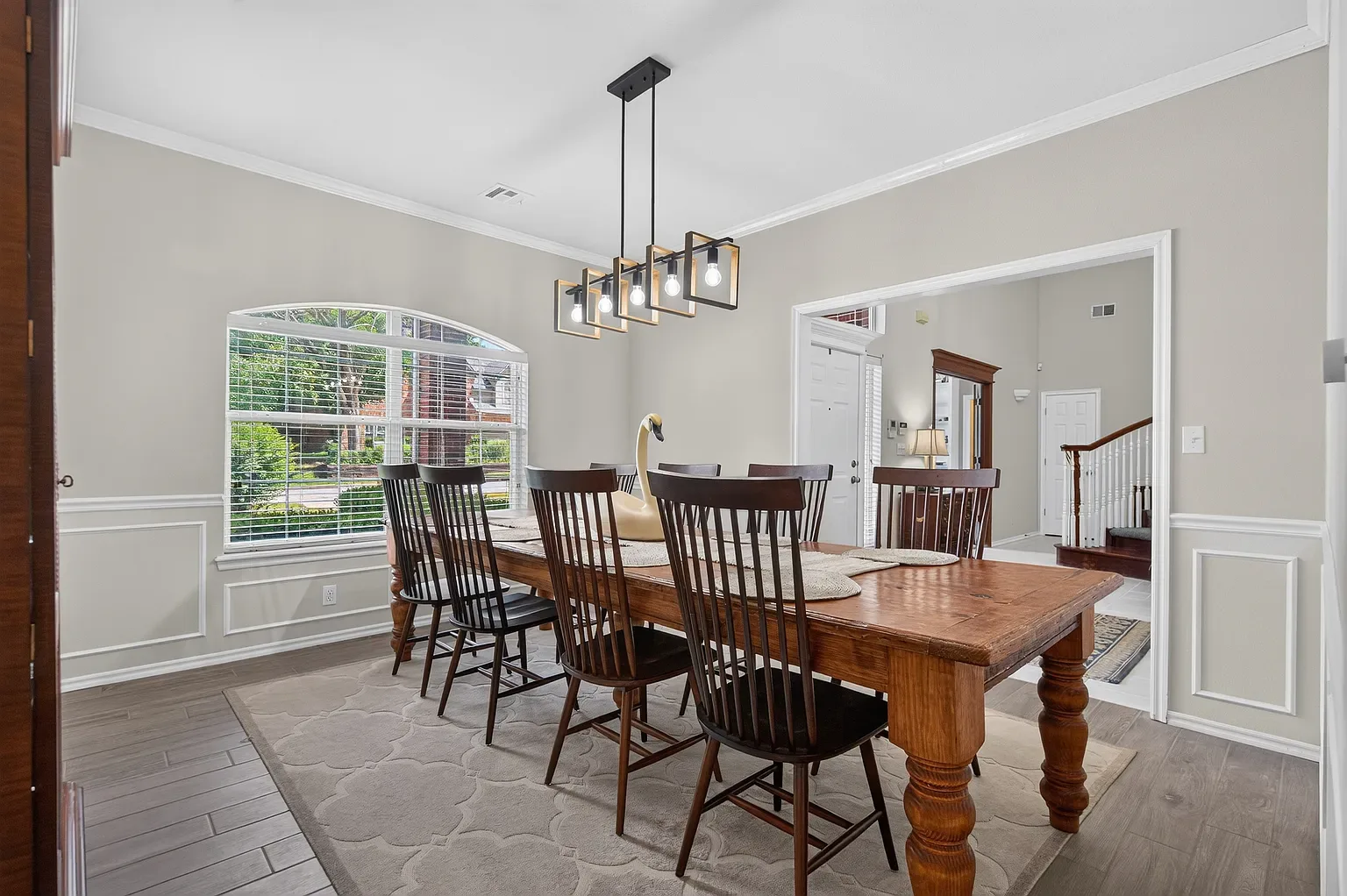 Formal dining room with wainscoting and wood floors
