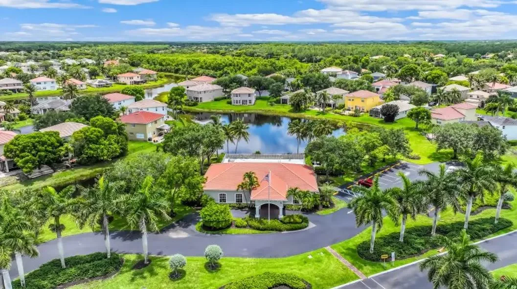 Aerial view of a community clubhouse and surrounding homes in an Estero neighborhood