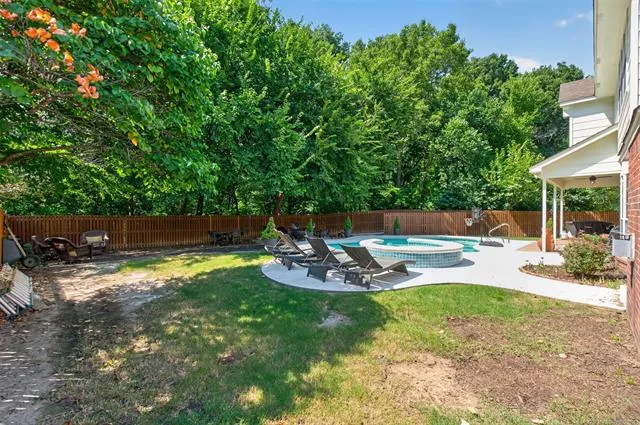 Second angle of the backyard in-ground pool and hot tub